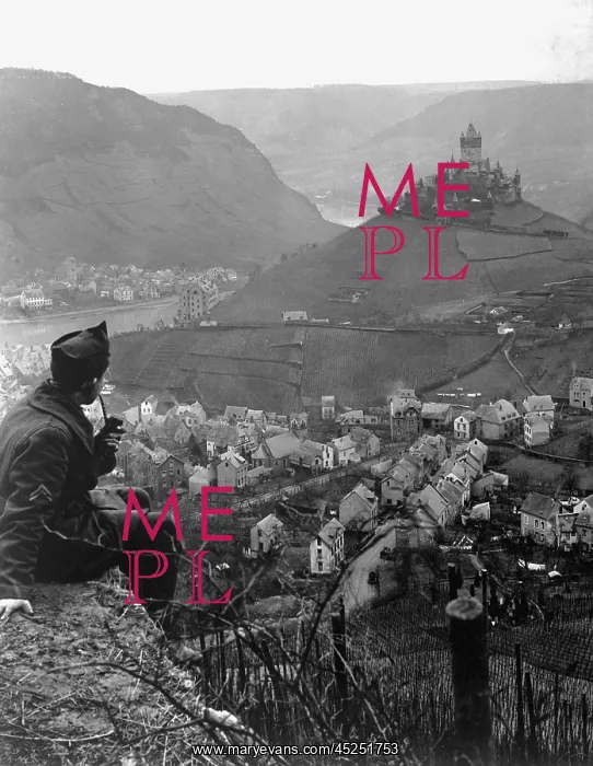 : American soldier looks toward an old castle perched : American soldier looks toward an old castle perched
