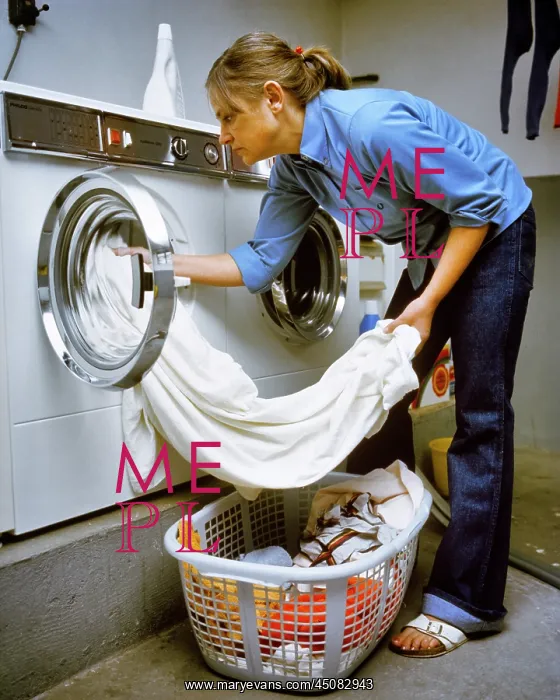 : Anonymous Housewife Unloading Finished Laundry : Anonymous Housewife Unloading Finished Laundry
