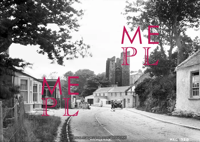 : Ardglass - a view up a street to the Castle, on the road is a motor car and man : Ardglass - a view up a street to the Castle, on the road is a motor car and man