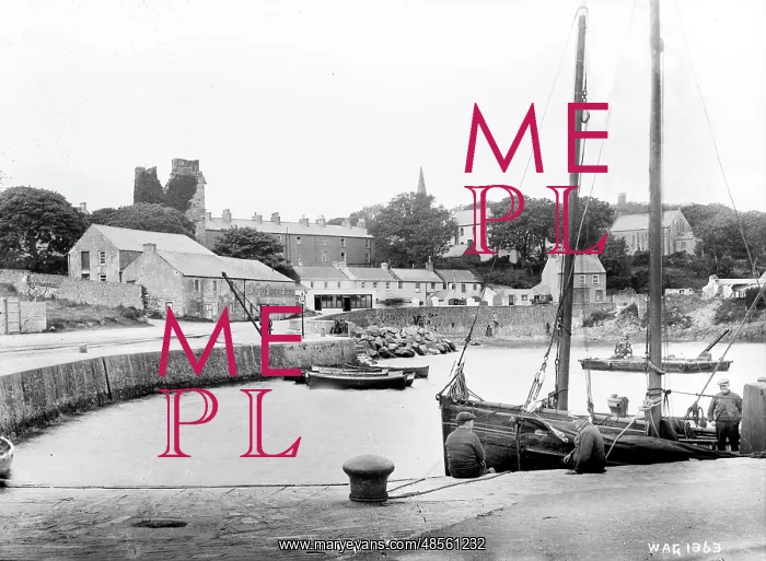 : Ardglass - a view from the pier with boat in the foreground to the town beyond : Ardglass - a view from the pier with boat in the foreground to the town beyond
