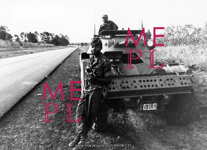 : Armed carriers with Zaire troops guard all access : Armed carriers with Zaire troops guard all access
