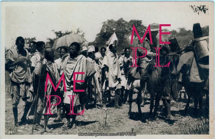 : Armed Italian officer on a mule with group of native bearers : Armed Italian officer on a mule with group of native bearers