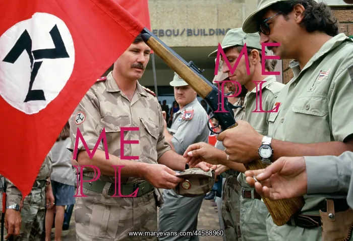 : Armed khaki-clad members of the AWB dip into an : Armed khaki-clad members of the AWB dip into an