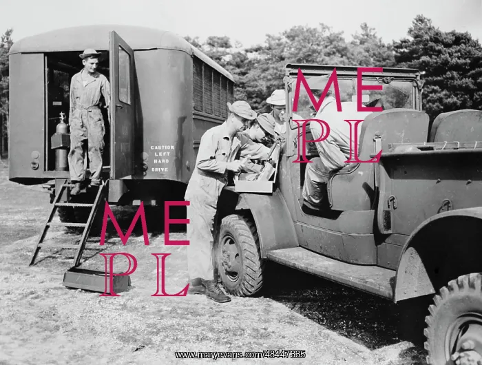 : An Army truck being repaired at a mobile unit : An Army truck being repaired at a mobile unit