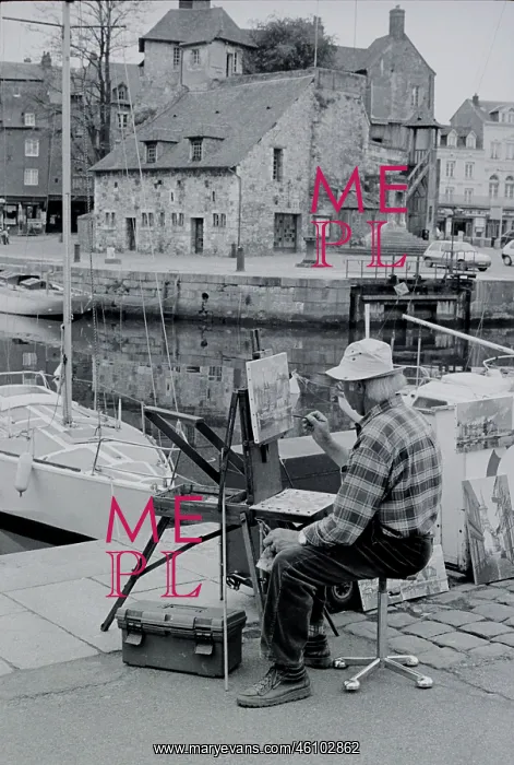 : Artist. Seated artist painting a harbour scene at Honfleur Normandie France : Artist. Seated artist painting a harbour scene at Honfleur Normandie France