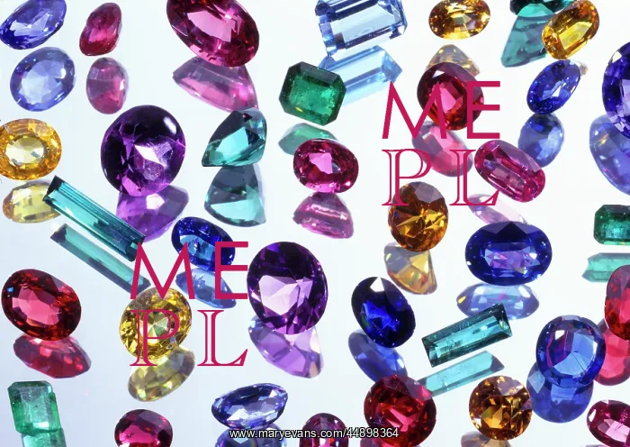  : ASSORTED GEMSTONES ON REFLECTIVE SURFACE