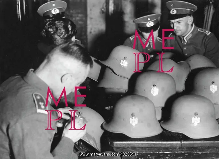 : Attaching badges on steel helmets, 1934 : Attaching badges on steel helmets, 1934