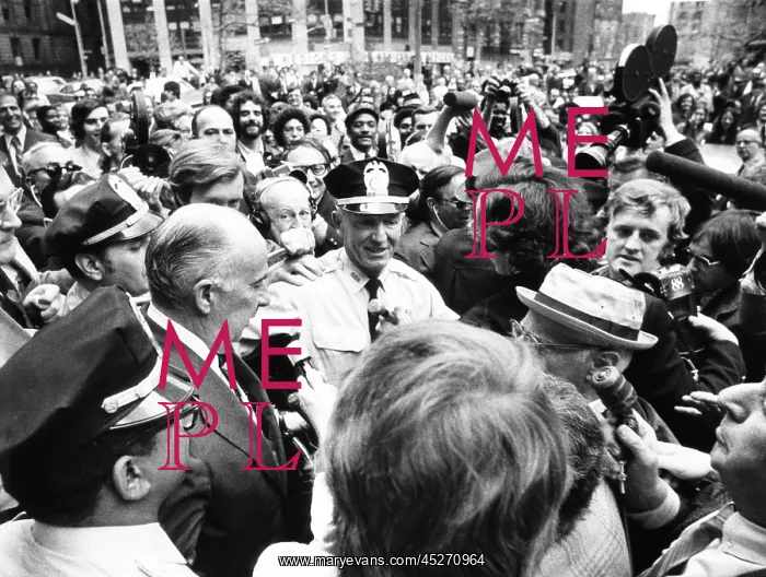 : Former Atty. Gen. John Mitchell was escorted by : Former Atty. Gen. John Mitchell was escorted by