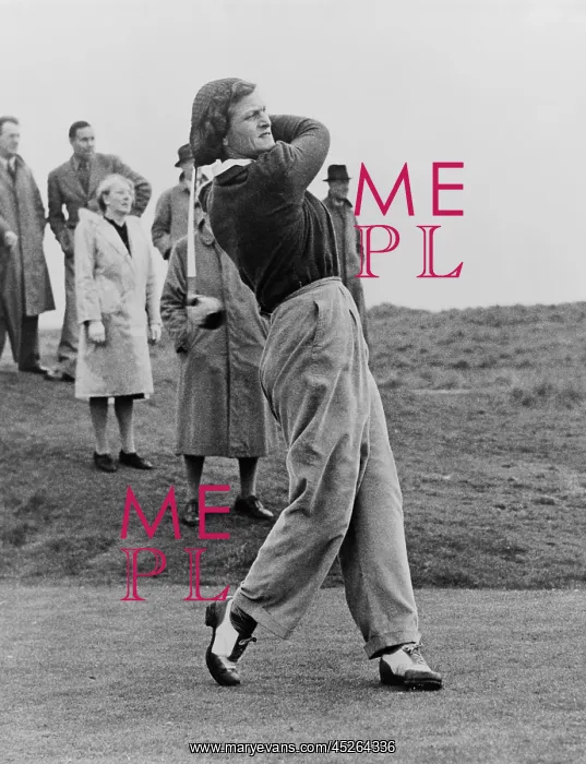 : Babe Didrikson, watching golf ball as she completes : Babe Didrikson, watching golf ball as she completes