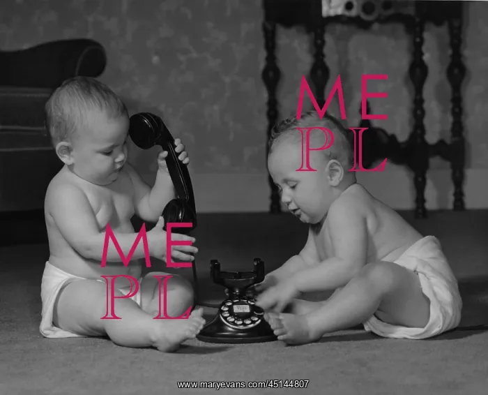 : Two babies sitting on the floor with old style telephone : Two babies sitting on the floor with old style telephone