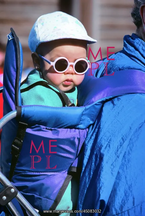 : Baby in Backpack Wearing Cap and Sunglasses : Baby in Backpack Wearing Cap and Sunglasses