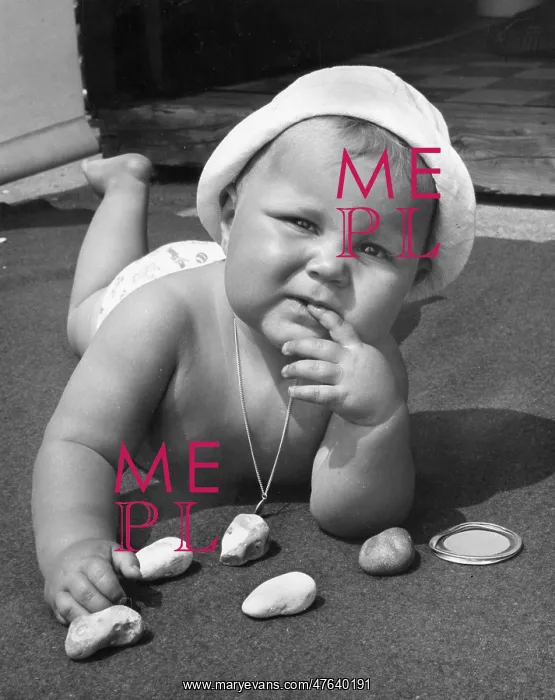 : Baby playing with pebbles : Baby playing with pebbles
