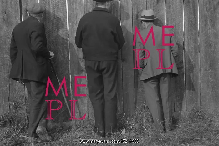 : The backs of three men watching a football ? : The backs of three men watching a football ?