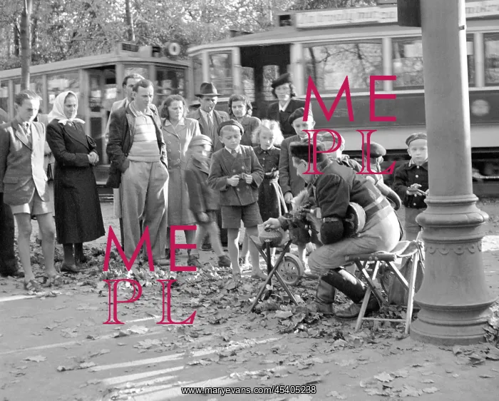  : Bagpiper. Prague, 1949. Street performer playing bagpipes draws a large crowd