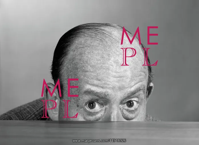 : Balding man peeking over desktop with only top : Balding man peeking over desktop with only top