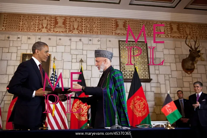 : Barack Obama and Hamid Karzai exchange documents : Barack Obama and Hamid Karzai exchange documents