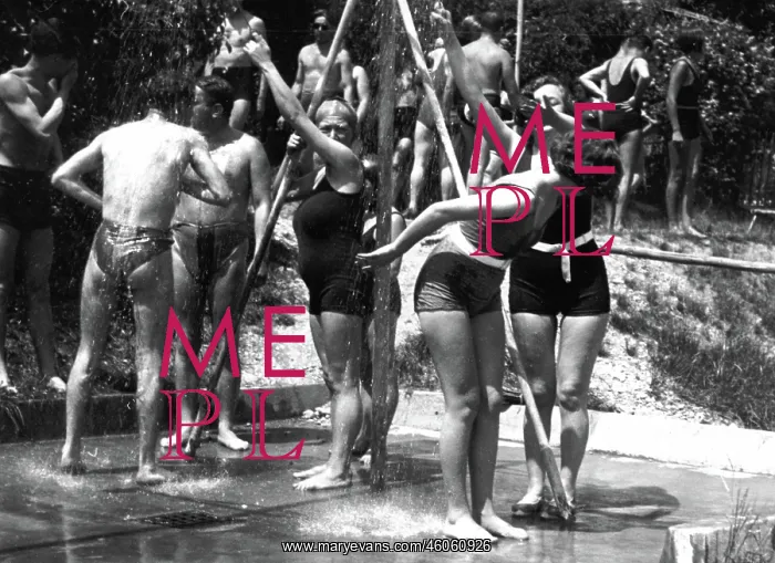: Some bathers are taking a shower : Some bathers are taking a shower