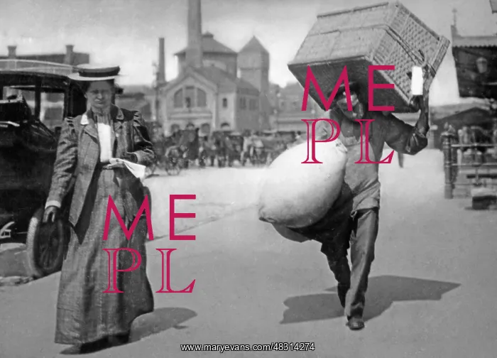 : A Berlin porter carrying suitcases, 1909 : A Berlin porter carrying suitcases, 1909