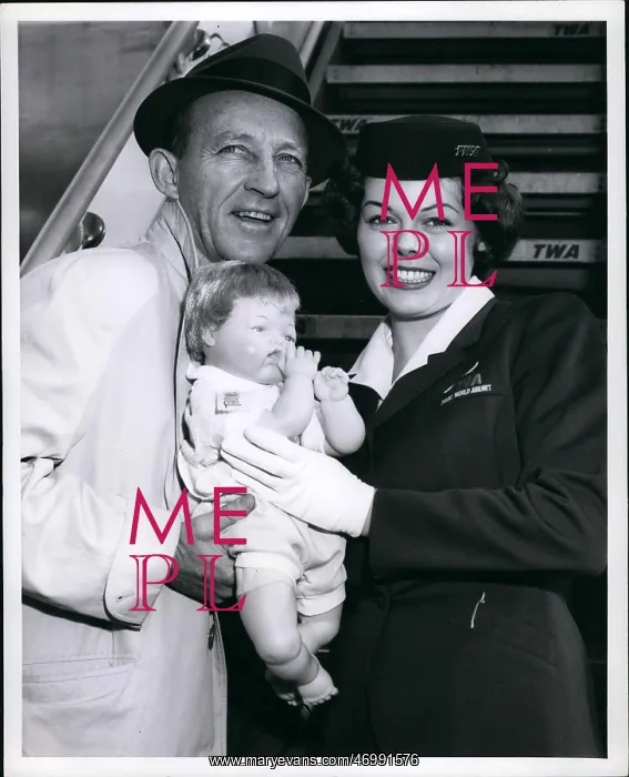 : Bing Crosby with air hostess and doll : Bing Crosby with air hostess and doll