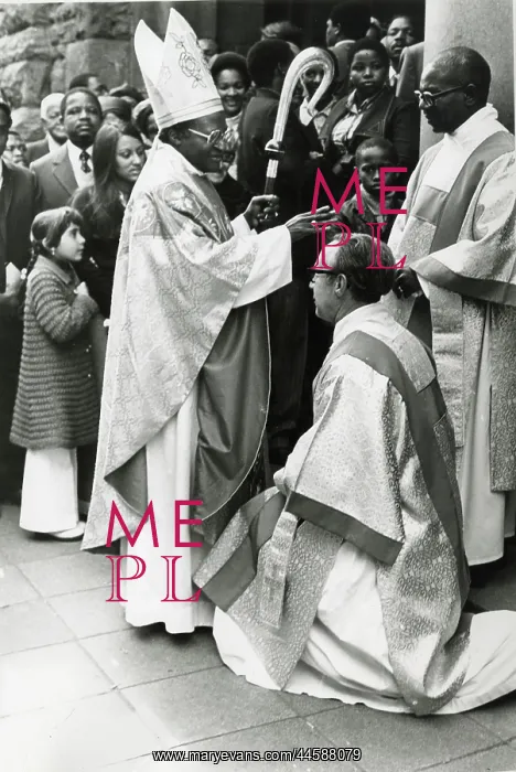 : Bishop Desmond Tutu standing and wearing religious : Bishop Desmond Tutu standing and wearing religious