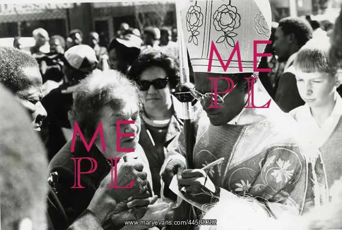 : Bishop Desmond Tutu writing and wearing religious : Bishop Desmond Tutu writing and wearing religious