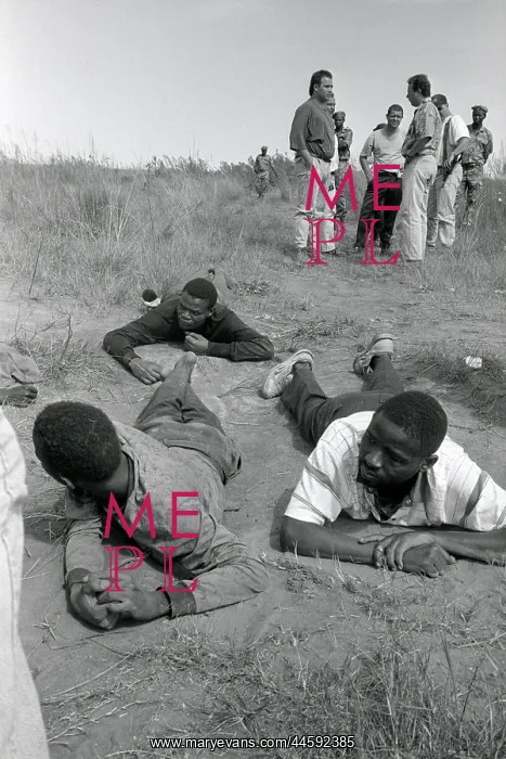: Three black men lie on the ground with police : Three black men lie on the ground with police