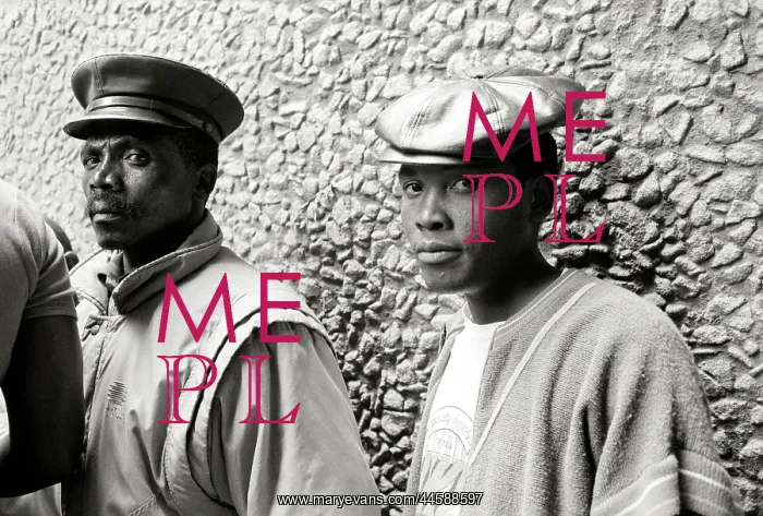 : Two black men standing against a pebbled wall : Two black men standing against a pebbled wall