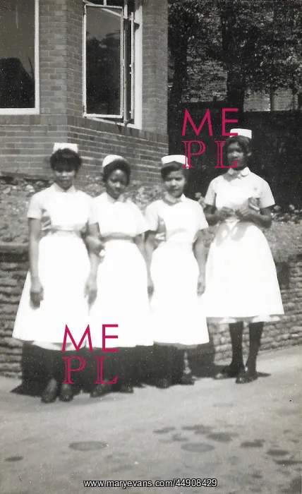 : Four black nurses stand by the hospital wall in Nottingham : Four black nurses stand by the hospital wall in Nottingham