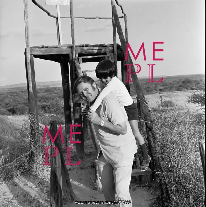 : Black and white photo of a man giving a young : Black and white photo of a man giving a young