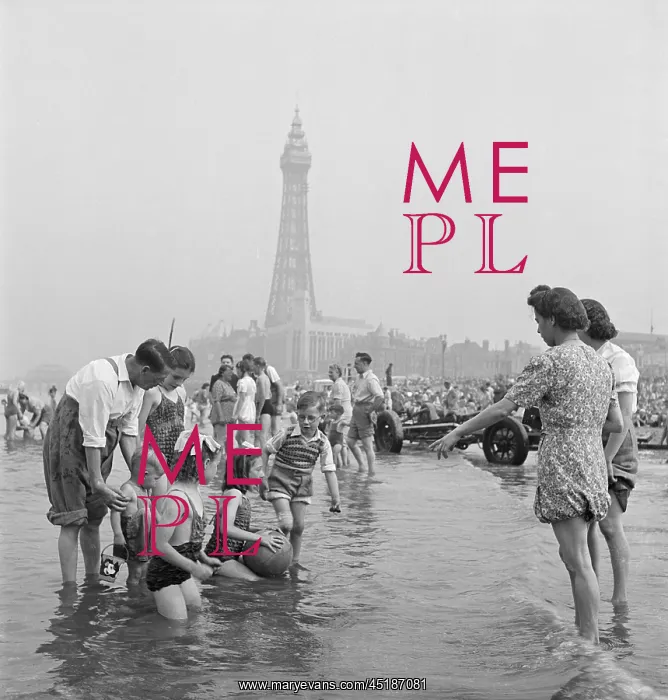 : Blackpool. A family group posing for a photograph in the shallows : Blackpool. A family group posing for a photograph in the shallows