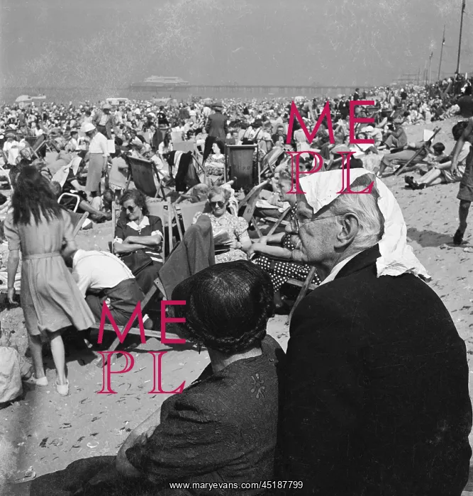 : Blackpool. Holiday makers on an crowded beach at Blackpool with an elderly : Blackpool. Holiday makers on an crowded beach at Blackpool with an elderly