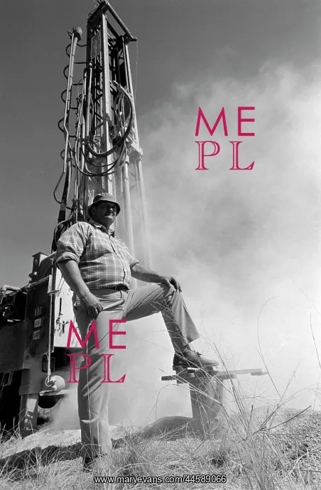 : Borehole drilling. A White man standing in front : Borehole drilling. A White man standing in front