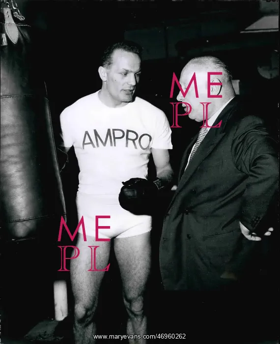  : Boxing. Feb. 28 Henry Cooper pauses in smashing away at the push ball to
