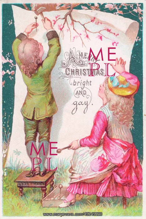 : Boy and girl attaching Christmas greeting to a tree : Boy and girl attaching Christmas greeting to a tree