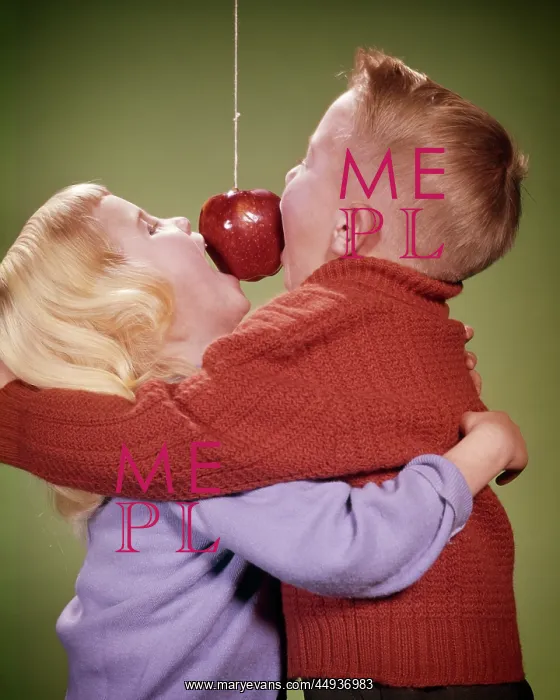 : Boy and Girl Hugging While Trying to Bite Apple : Boy and Girl Hugging While Trying to Bite Apple