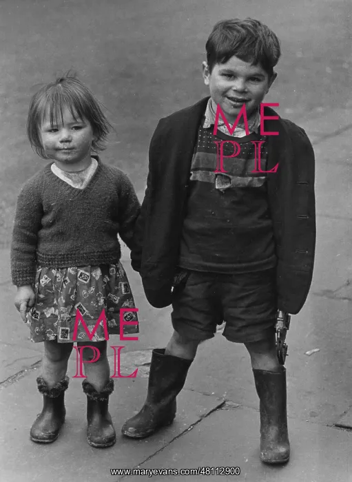 : Boy and girl standing on a pavement : Boy and girl standing on a pavement