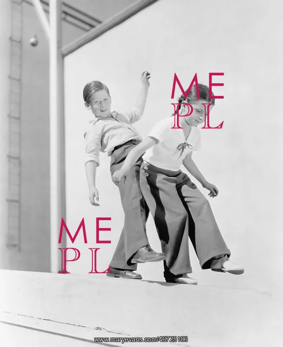 : Boy and girl trying to balance on a ledge : Boy and girl trying to balance on a ledge