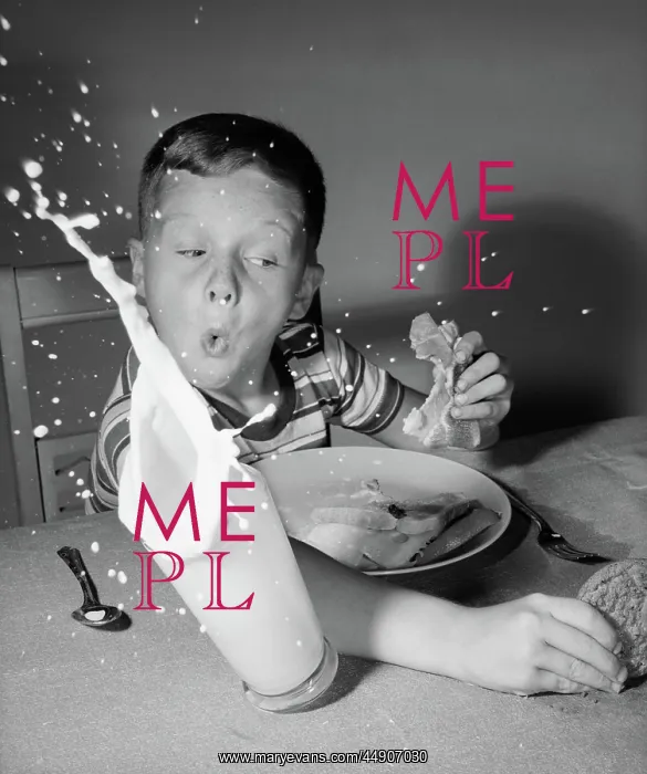: Boy having lunch knocking over milk reaching : Boy having lunch knocking over milk reaching