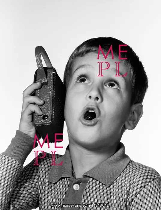 : Boy holding transistor radio up to his ear while : Boy holding transistor radio up to his ear while
