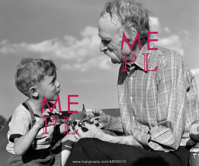 : Boy looking at model propeller plane with grandfather : Boy looking at model propeller plane with grandfather