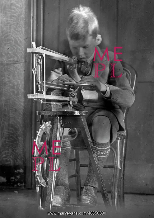  : Boy operating a fretsaw