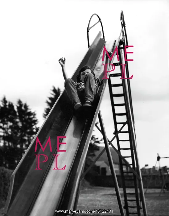 : Boy on a playground slide : Boy on a playground slide