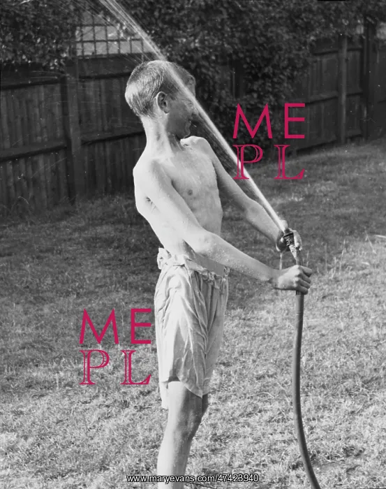 : Boy plays with water hose 1933 : Boy plays with water hose 1933
