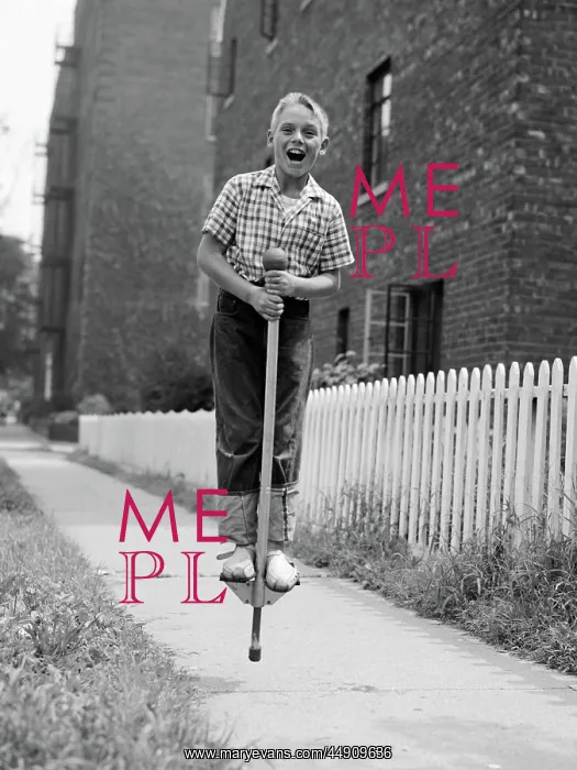  : Boy on pogo stick on sidewalk