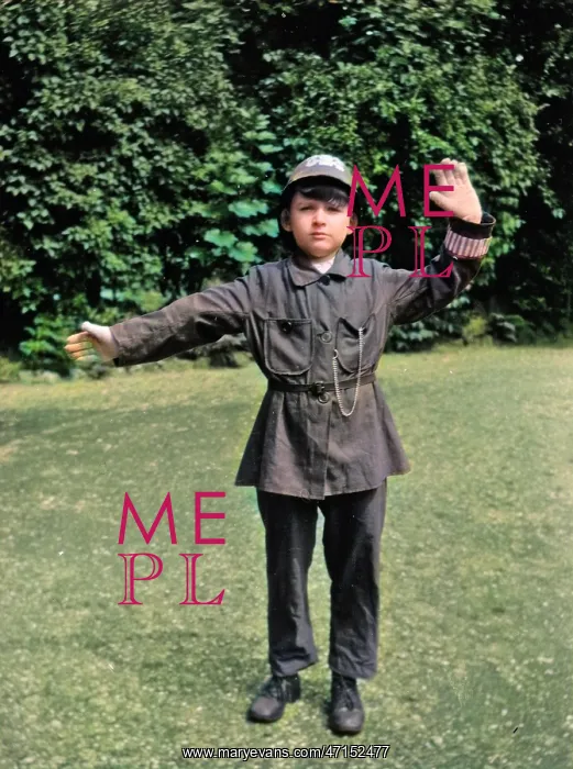 : Boy in policeman's uniform in a garden : Boy in policeman's uniform in a garden