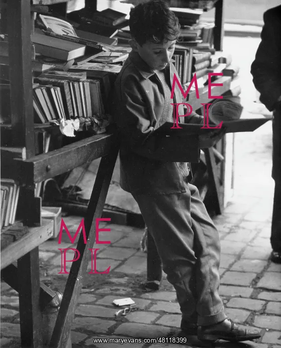 : Boy reading at secondhand book stall : Boy reading at secondhand book stall