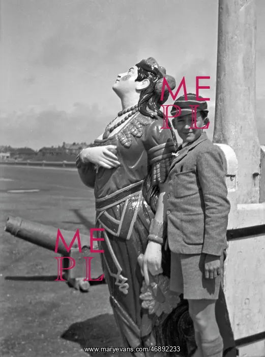 : Boy in school uniform with figurehead at seaside : Boy in school uniform with figurehead at seaside