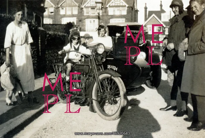 : Boy sitting on a 1918 Harley Davidson motorcycle : Boy sitting on a 1918 Harley Davidson motorcycle