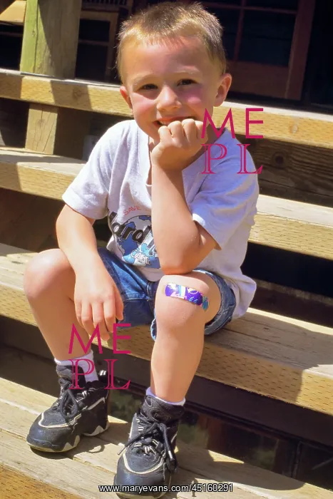 : Boy Sitting on Steps with Adhesive Bandage on : Boy Sitting on Steps with Adhesive Bandage on
