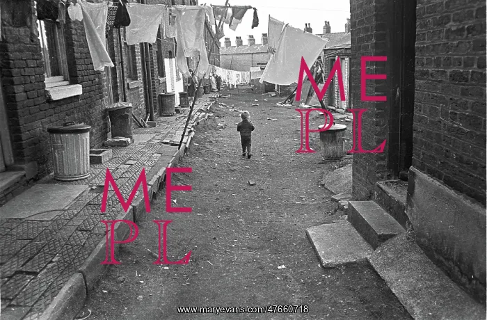 : Boy in slum housing yard : Boy in slum housing yard
